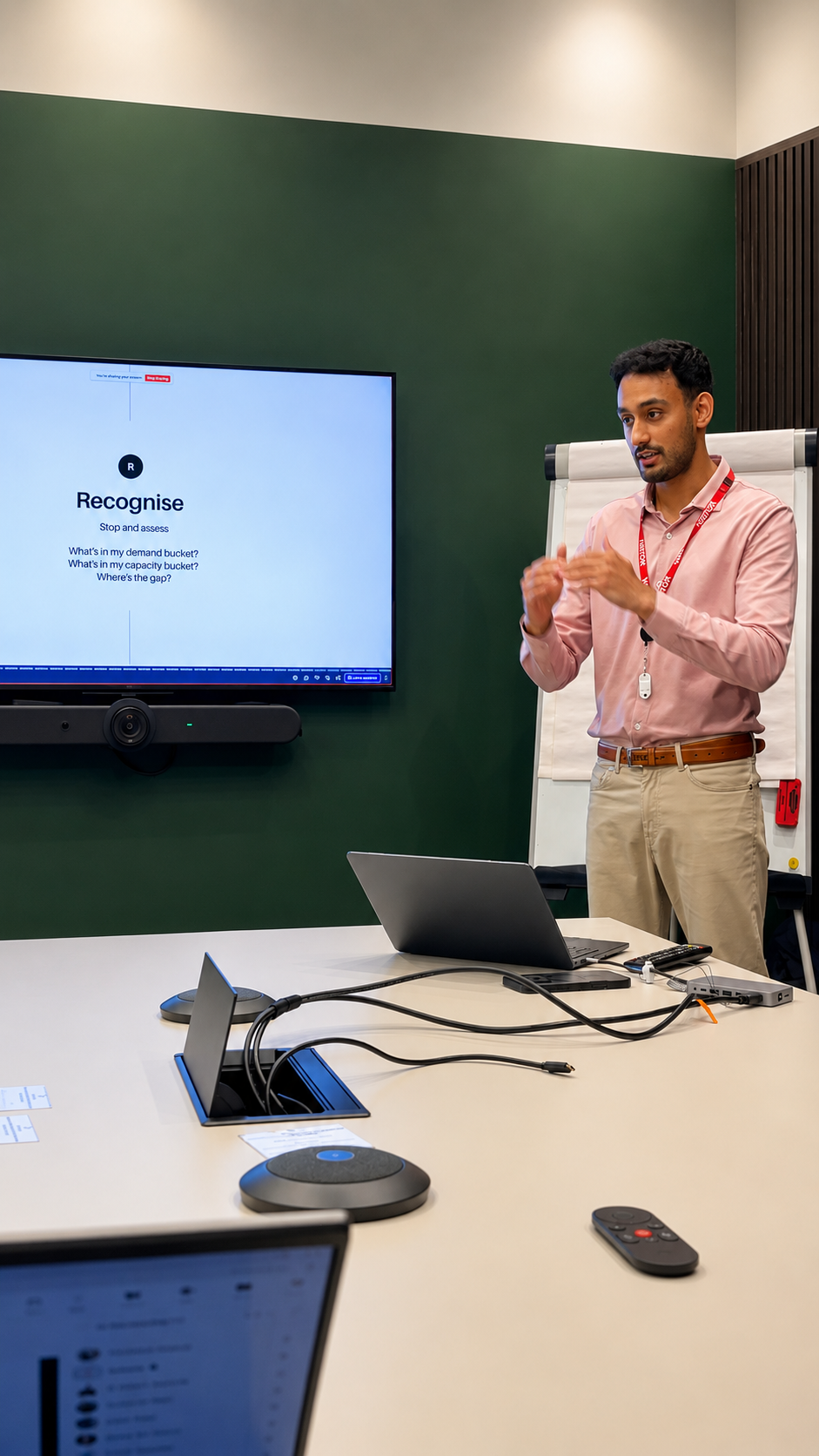 Dr Aakarsh Srivastava explaining a point during a workshop, with a slide and flipchart behind him